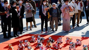 People watch Sony’s robotic dogs ‘Aibo’ during a ritual ceremony Sichi-Go-San, which is usually held for praying for children’s health and wellbeing, at the Kanda Myojin shrine in Tokyo, Japan, on November 11, 2022. (Reuters)