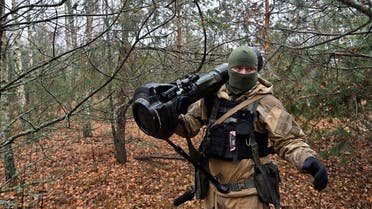 This photograph taken on November 3, 2022 shows a Ukrainian border guard carrying an Anglo-Swedish NLAW anti-tank missile launcher at a fortified position near the Ukrainian border with Russia and with Belarus. (AFP)