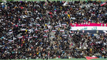 This aerial view shows locals in the city of Nasiriyah in Iraq’s southern Dhi Qar province gathering along al-Zaitoon (Olive) bridge on November 28, 2022 to commemorate the third anniversary of the quelling of a protest and sit-in against deteriorating living conditions and lack of services at the same location by Iraqi security forces. (AFP)