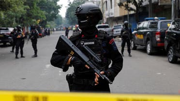 An armed police officer stands guard following a blast at a district police station, that according to authorities was a suspected suicide bombing, in Bandung, West Java province, Indonesia, December 7, 2022. (Reuters)