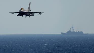A Turkish F16 fighting jet flies over naval ships during an annual NATO naval exercise on Turkey's western coast on the Mediterranean, Sept. 15, 2022. (AP)
