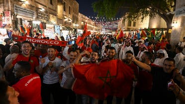 Morocco supporters celebrate in the streets in Doha on December 6, 2022 after their team won the Qatar 2022 World Cup round of 16 football match between Morocco and Spain.