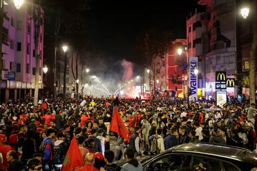 Moroccans celebrate their team's victory after the Qatar 2022 World Cup round of 16 football match between Morocco and Spain, in Rabat, on December 6, 2022. (AFP)