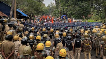 Police officers stand guard near the barricades during a protest rally by the supporters of the proposed Vizhinjam port project in the southern state of Kerala, India, November 30, 2022. (Reuters)