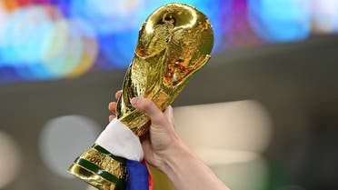 A France supporter carries a replica of the trophy ahead of the Qatar 2022 World Cup round of 16 football match between France and Poland at the Al-Thumama Stadium in Doha on December 4, 2022. (AFP)