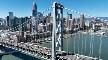 In an aerial view, cars drive by the San Francisco skyline as they cross the San Francisco-Oakland Bay Bridge on October 27, 2022 in San Francisco, California. (AFP)
