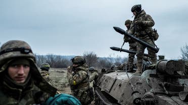 Servicemen of the Carpathian Sich Battalion are seen near an Armoured Personnel Carrier (APC) on a frontline, as Russia's attack on Ukraine continues, near the town of Lyman, Donetsk region, Ukraine December 8, 2022. (Reuters)