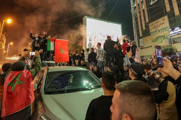 Palestinians celebrate Morocco’s win over Portugal in the streets of the occupied West Bank city of Hebron. (AFP)