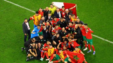 Morocco team members pose for a group photo and celebrate after the match as Morocco qualifies for the semifinals. (Reuters)