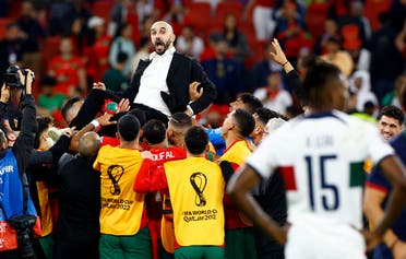 Morocco coach Walid Regragui with players celebrate after the match as Morocco progresses to the semifinals. (Reuters)