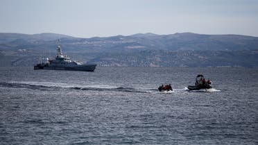A rescue boat escorts a dinghy with migrants from Afghanistan as a Frontex vessel patrols in the background, on the island of Lesbos, Greece, February 28, 2020. REUTERS/Costas Baltas