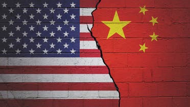 USA vs China stock photo Cracked brick wall painted with an American flag on the left and a Chinese flag on the right.