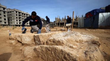 Palestinian workers excavate a recently-discovered Roman cemetery containing ornately decorated graves in Beit Lahia in the northern Gaza Strip, on December 12, 2022. (AFP)