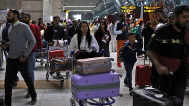 Travellers push carts with their luggage at the departure area of Terminal 3 at Indira Gandhi International Airport in New Delhi, India, December 14, 2022. REUTERS/Anushree Fadnavis