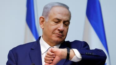 Israeli Prime Minister Benjamin Netanyahu looks at his watch before delivering a statement at the Knesset, Israel’s parliament, in Jerusalem, on December 19, 2018. (Reuters)