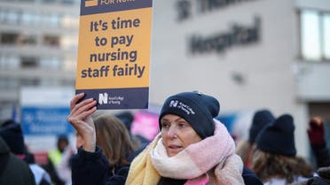 NHS nurse holds a placard during a strike, due to a dispute with the government over pay, outside St Thomas’ Hospital in London, Britain, on December 15, 2022. (Reuters)