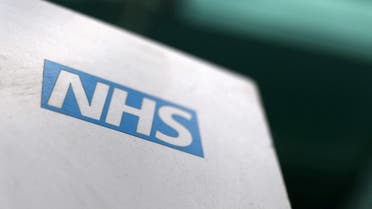 An NHS logo is displayed outside a hospital in London. (Reuters)