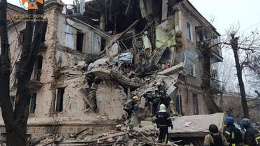 This handout picture taken and released by Ukrainian State Emergency Service on December 16, 2022 shows rescuers working at a three-story building heavily damaged following a Russian missile strike in Ukrainian city of Kryvyi Rih. (AFP) 