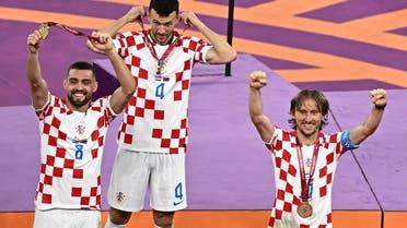 From L: Croatia’s midfielder #08 Mateo Kovacic, Croatia’s midfielder #04 Ivan Perisic and Croatia’s midfielder #10 Luka Modric celebrate with medals after winning the Qatar 2022 World Cup football third place play-off match between Croatia and Morocco at Khalifa International Stadium in Doha on December 17, 2022. (AFP)