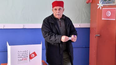 A Tunisian voter casts his ballot at a polling station in Mnihla district outside Tunis on December 17, 2022, during the parliamentary election. (AFP)