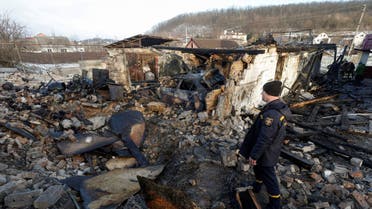 A member of the State Emergency Service stands at a site of a residential building damaged during a Russian drone strike, amid Russia's attack on Ukraine, in the village of Stari Bezradychi, in Kyiv region, Ukraine December 19, 2022. (Reuters)