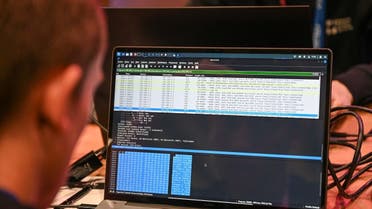 An IT specialist performs a hacking demonstration at the International Cybersecurity Forum (FIC) in Lille, northern France, on June 8, 2022. (Photo by DENIS CHARLET / AFP)