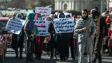 Women hold placards during a protest calling for their rights to be recognized, near the Shah-e-Do Shamshira mosque in Kabul on November 24, 2022. (AFP)