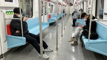 Commuters wear protective masks while they ride a subway train as coronavirus disease (COVID-19) outbreaks continue in Shanghai, China, on December 20, 2022. (Reuters)