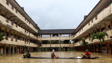 Residents are rescued by a boat from the flood relief centre as the flood water rise and partially submerged the building at Dungun, Terengganu, Malaysia December 21, 2022. (Reuters)
