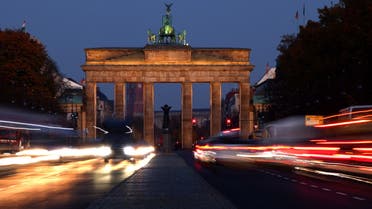 Car traffic makes its way on a road in front of the illuminated Brandenburg Gate, in central Berlin, Germany, November 15, 2022. (Reuters)