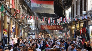 Syrians shop at a market as they celebrate the birth of Islam’s Prophet Mohammed in the capital Damascus on October 8, 2022. (AFP)