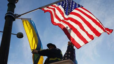 A worker installs Ukrainian and U.S. flags along Pennsylvania Avenue leading to the U.S. Capitol, ahead of a visit by Ukraine's President Volodymyr Zelenskiy for talks with U.S. President Joe Biden and an address to a joint meeting of Congress in Washington, U.S., December 21, 2022. (Reuters)