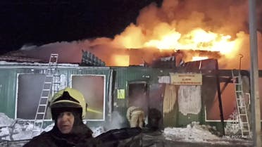 Firefighters work to extinguish a fire in an unregistered home for the elderly in the Siberian city of Kemerovo, Russia December 24, 2022, in this still image taken from video. (Reuters)