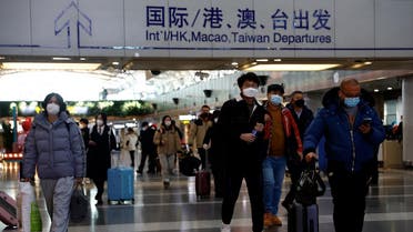 Travellers walk with their luggage at Beijing Capital International Airport, amid the coronavirus disease (COVID-19) outbreak in Beijing, China, on December 27, 2022. (Reuters)