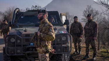 Italian soldiers serving in a NATO-led international peacekeeping mission in Kosovo patrol near a road barricaded with trucks by Serbs in the village of Rudare near the town of Zvecan on December 26, 2022. (AFP)