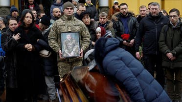 Natalia Holub reacts over a coffin with the body of her son Volodymyr Yezhov, Ukrainian serviceman and game designer for world renowned games S.T.A.L.K.E.R. and Cossacks, who was recently killed in a fight against Russian troops near the town of Bakhmut, amid Russia’s attack on Ukraine, in Kyiv, Ukraine December 27, 2022. (Reuters)
