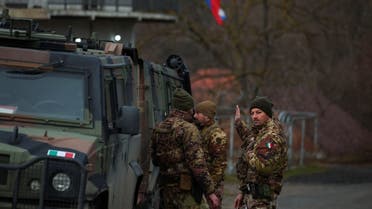 Members of the Italian Armed Forces, part of the NATO peacekeepers mission in Kosovo, stand guard near a roadblock in Rudare, near the northern part of the ethnically-divided town of Mitrovica, Kosovo, on December 28, 2022. (Reuters)