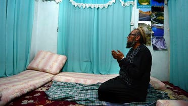 (FILES) In this file photo taken on February 12, 2015, former Soviet soldier Bakhretdin Khakimov, who works at the Jihad Museum that contains exhibitions about the Soviet invasion of 1979 and the Afghan resistance, prays in his home in Herat Province. Khakimov, who came to Afghanistan to fight the mujahideen more than four decades ago but chose to stay back after the exit of the Red Army has died, officials said. (Photo by Aref KARIMI / AFP)