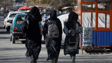Afghan female students walk near Kabul University in Kabul. As well as banning women from working with NGOs the group has also banned women from being educated in secondary schools and universities. (Reuters)