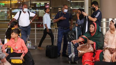 Passengers wait with their luggage at the Chhatrapati Shivaji Maharaj International Airport in Mumbai, India, on December 22, 2022. (Reuters)