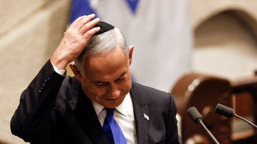Israeli Prime Minister-designate Benjamin Netanyahu adjusts his skull cap after speaking at a special session of Israel’s parliament, to approve and swear in a new right-wing government, in Jerusalem on December 29, 2022. (AFP)