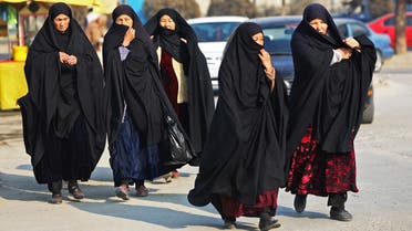 Afghan women walk through a street in Kabul on December 28, 2022. (AFP)