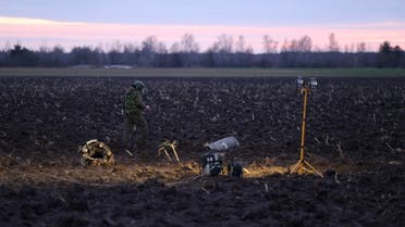 An investigator walks near fragments of a munition, what Belarus’ defense ministry said were parts of a Ukrainian S-300 missile downed by Belarusian air defenses outside the village of Harbacha in the Grodno region, Belarus, on December 29, 2022. (Reuters)