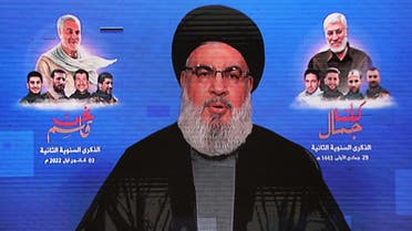This picture taken on January 3, 2022 shows a view of a screen displaying a televised speech by the head of the Lebanese Shia movement Hezbollah Hassan Nasrallah, airing during a memorial service marking the second anniversary of a US drone strike that killed the top commander of the Iranian revolutionary guard corps (IRGC) Qasem Soleimani alongside Iraqi commander Abu Mahdi al-Muhandis, at a hall in a school in the southern suburb of Lebanon’s capital Beirut. (AFP)