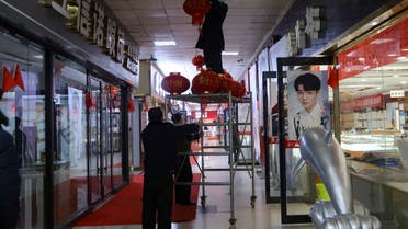 Staff members hang lanterns ahead of the New Year at a glasses market, amid of the coronavirus disease (COVID-19) outbreak, in Wuhan, Hubei province, China December 31, 2022. (Reuters)