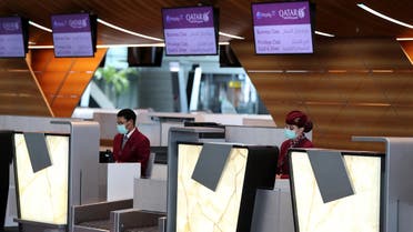 Check-in counter personnel wear masks and gloves at Doha's Hamad International Airport amid measures implemented to prevent the spread of the new coronavirus COVID-19, on March 31, 2020. (File photo: AFP)