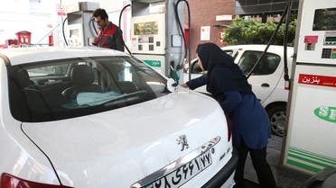 A women fills up her car's tank at a petrol station, after fuel price increased in Tehran, Iran November 15, 2019, supplied by WANA (West Asia News Agency). (Reuters)