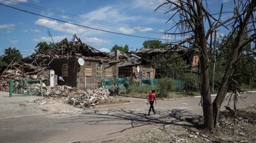A local resident walks near buildings destroyed by Russian military strike, amid Russia's invasion on Ukraine, in the town of Druzhkivka, in Donetsk region, Ukraine June 6, 2022. REUTERS/Gleb Garanich