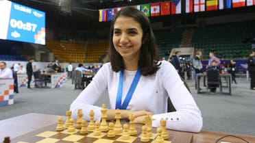 Sara Khadem of Iran sits in front of a chess board during a game.  (Reuters)