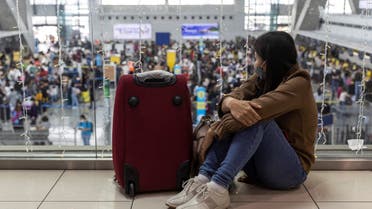 A passenger bound for a flight to Japan waits for her delayed flight at the Ninoy Aquino International Airport, in Pasay City, Metro Manila, Philippines, January 2, 2023. (Reuters)